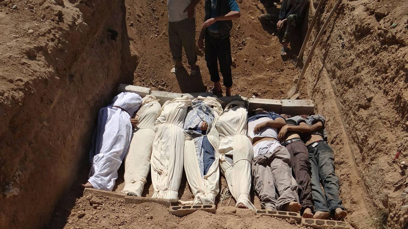 This image provided by by Shaam News Network on Thursday, Aug. 22, 2013, which has been authenticated based on its contents and other AP reporting, purports to show several bodies being buried in a suburb of Damascus, Syria during a funeral on Wednesday, Aug. 21, 2013. Syrian government forces pressed their offensive in eastern Damascus on Thursday, bombing rebel-held suburbs where the opposition said the regime had killed more than 100 people the day before in a chemical weapons attack. The government has denied allegations it used chemical weapons in artillery barrages on the area known as eastern Ghouta on Wednesday as "absolutely baseless." (AP Photo/Shaam News Network)